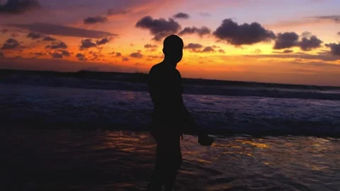 Silhouette of man walking on the beach at sunset, recreating at tropical island Video stock 220295044