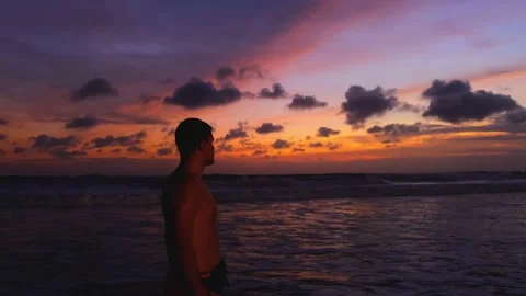 Silhouette of man walking on the beach at sunset, recreating at tropical island Video stock 224747495