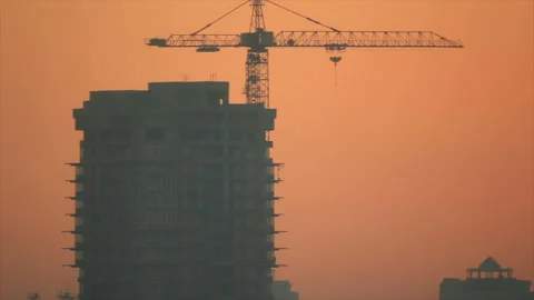 Silhouette of a man walking up to the edge of an open balcony at a construct Stock Footage 170759281