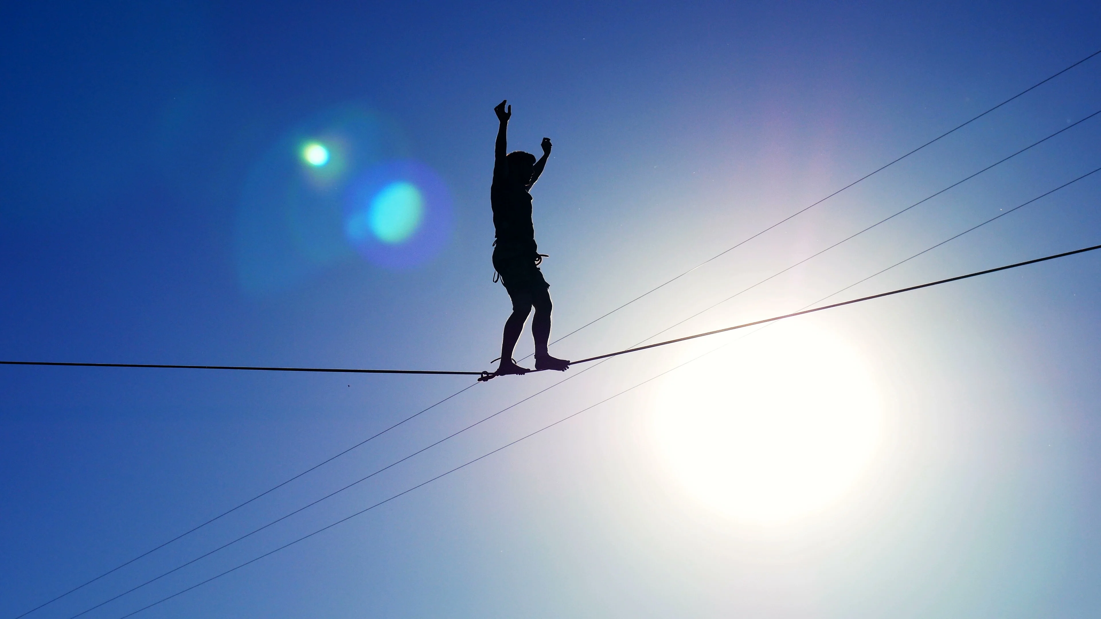 Silhouette of a man walking on a rope on, Stock Video