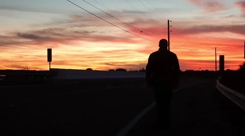 Silhouette of man walking into sunset Stock-Footage 45300242