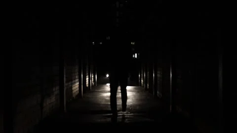 Silhouette of a man walking through the dark tunnel to the car. Stock Footage 225156022