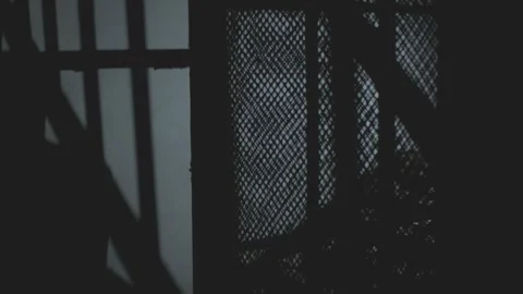 Silhouette of man walking through industrial elevator shaft at night. Stock Footage 344997783
