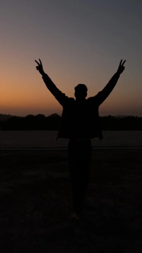 Silhouette Man Walking Toward Setting Sun Under Golden Sky Stock Footage 320827986