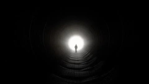 Silhouette of Man Walking Towards Light in Dark Tunnel Stock Footage 315920800