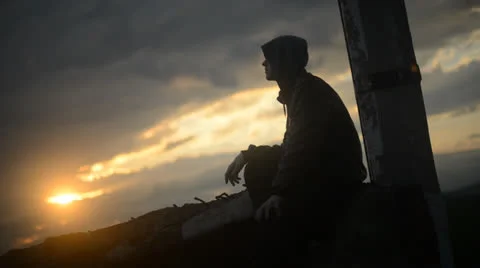 Silhouette of a man watching the sunset clouds Stock Footage 25891090
