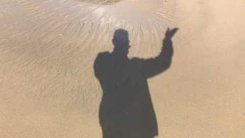 Silhouette of man waving to the camera Stock Footage 265012475