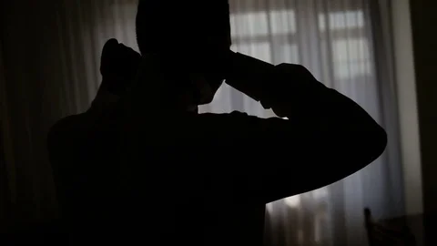 Silhouette of a man wears a butterfly Stock Footage 83429892
