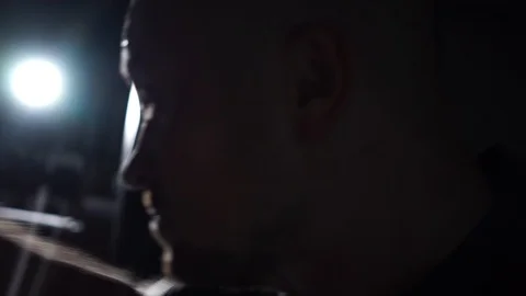 Silhouette of the man which beats to a punching bag at the night Stock Footage