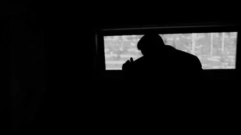 The silhouette of a man who throws a jacket over his shoulders Stock Footage 197509709