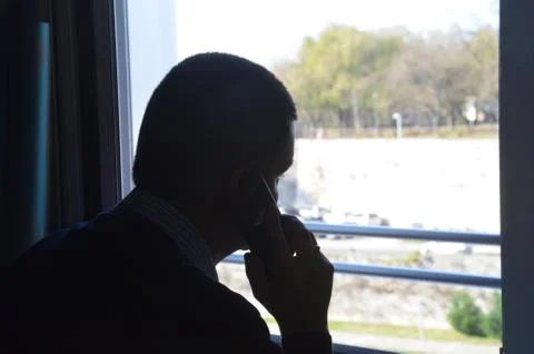 Silhouette of a man on the window Stock Photos
