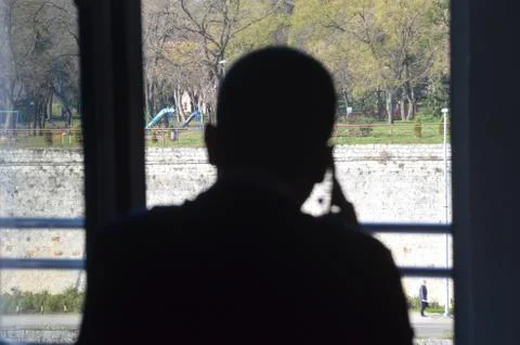Silhouette of a man on the window Stock Photos