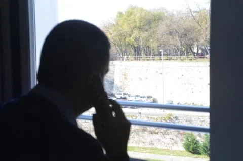 Silhouette of a man on the window Stock Photos