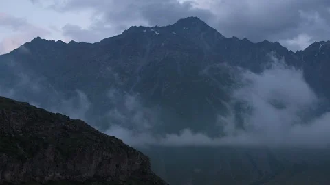 Silhouette of Massive Mountain Range at Dusk. Low cloud in Caucasus Mountains Stock Footage 255311304