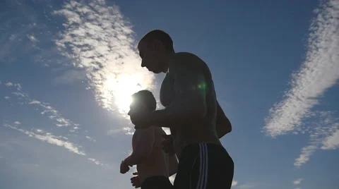 Silhouette of men jogging in the country at sunset time. Two male jogger Stock Footage