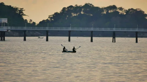 Silhouette men rowing boat in deep sea water Stock Footage 130582834