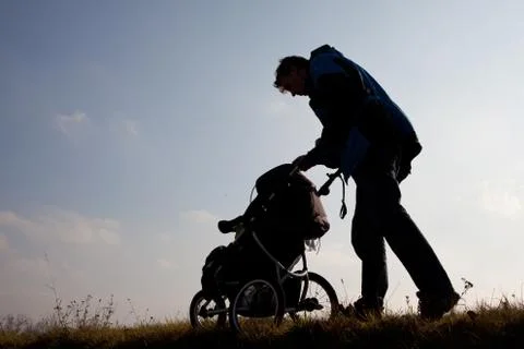 Silhouette  of men with stroller Stock Photos