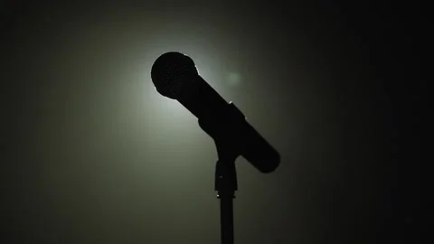 The silhouette of the microphone in the dark on stage. Stock Footage 157522489