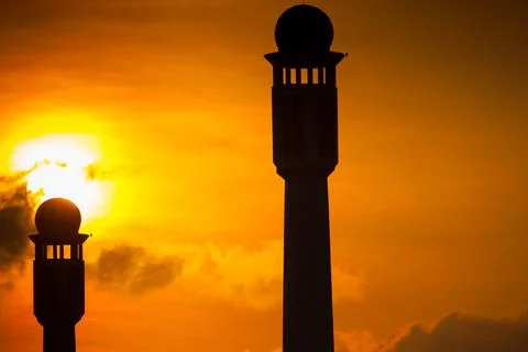 Silhouette of a mosque at sunset Stock Photos