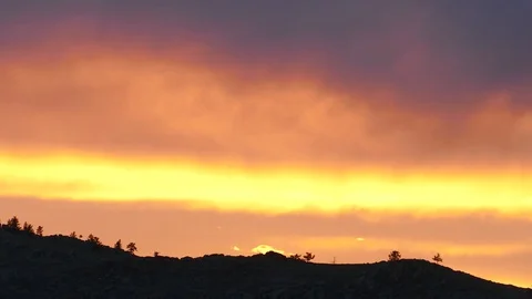 Silhouette of a mountain and trees against a background of a yellow sunset sky. Stock Footage 80093014