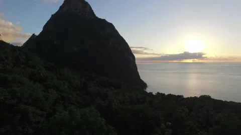 Silhouette of mountain as sun sets over the ocean Stock Footage 66339381