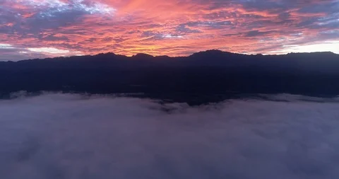 Silhouette mountains and white clouds during sunrise Stock Footage 107573386