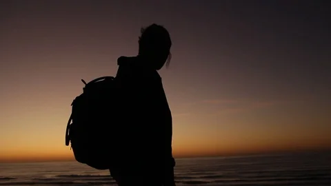 Silhouette by the ocean Stock Footage 123143431