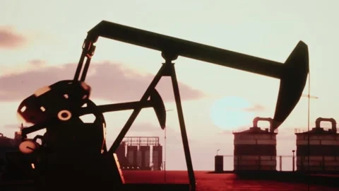 Silhouette of oil pump jack working at sunrise in oilfield industrial site. Stock Footage 337605927