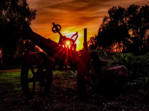 Silhouette of an old tractor against a dramatic sunset sky Fotos de archivo