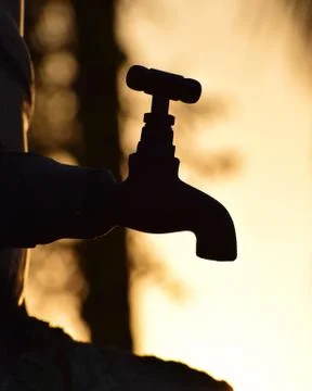 Silhouette of old vintage metal tap in natural dry environment, water shortage Stock Photos