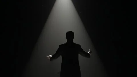 Silhouette of orchestra conductor is directing the final chord of the concert Stock Footage 247558655