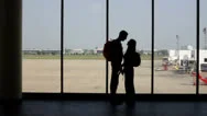 Silhouette Of Pair Of Lovers Near The Window In Airport Stock Footage