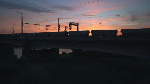Silhouette of passing freight train at sunset Stock Footage 204104405