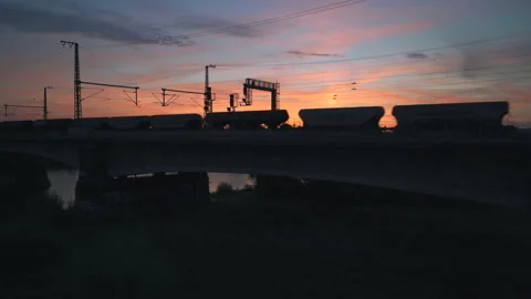 Silhouette of passing freight train at sunset Stock Footage 204104683