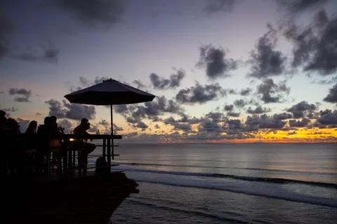 Silhouette of people at bar sunset background Stock Photos