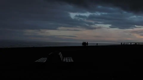 Silhouette of people on Beach with a Cloud Sky and the Horizon in the background Stock Footage 279073501