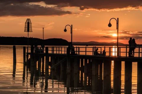Silhouette of people on a dock Stock Photos