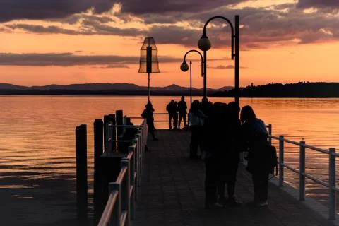 Silhouette of people on a dock Stock Photos