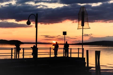Silhouette of people on a dock Stock Photos