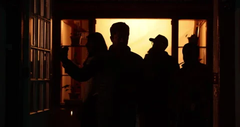 Silhouette of people at a Door Stockbeeldmateriaal 340352480