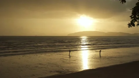 Silhouette people on the dramatic sunset over the mountains and the sea beach Stock Footage 153507033