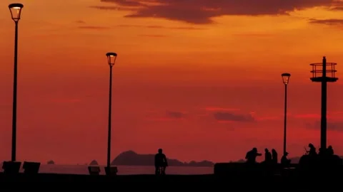 Silhouette People at Dramatic Sunset Promenade with Lampposts, Golden Hour Stock-Footage 329616164