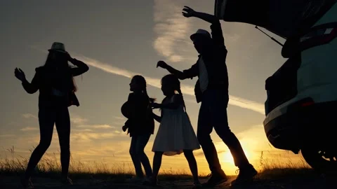 Silhouette of people having fun at sunset. Happy family with children travels by Stock-Footage 148808901