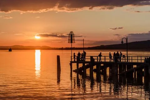 Silhouette of people at sunset Stock Photos
