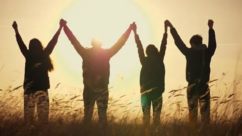 Group Holding Hands Sunset