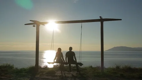 Silhouette of people on the swing Stock Footage 95930286