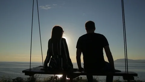 Silhouette of people on the swing Stock Footage 95930307