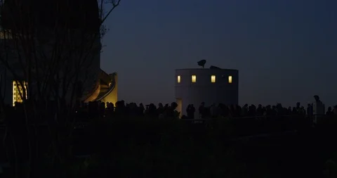 Silhouette of people watching the Lunar Eclipse in Los Angeles, California Stock Footage 99158950