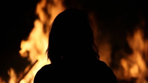 Silhouette of person in front of flames Stock Footage 122306815
