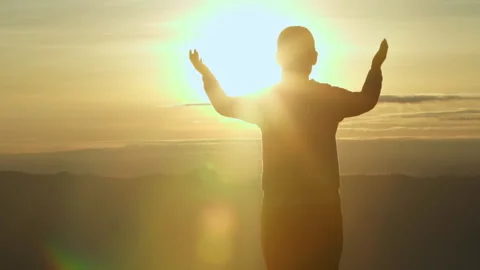 Silhouette of Person hands open palm up worship God helping repent catholic.. Stock Footage 336997679